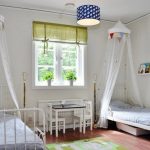 Lits d'enfant en métal avec un auvent adossé à la fenêtre