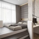 Podium avec un lit et une zone de travail derrière le verre