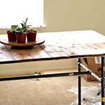 La table de planches avec un cadre en métal de tuyaux