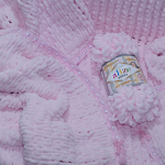 Tresses roses délicates d'un fil de peluche inhabituel