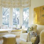 Intérieur d'un salon ensoleillé avec stores romains aux fenêtres