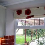Cascade Roman light curtains with red gerberas