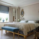 Combination of blue roman and light classic curtains in the bedroom