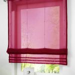 Cortinas burdeos translúcidas para una pequeña ventana.
