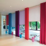 Multi-colored blinds on the windows to the floor