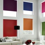 Rideaux enroulés de toutes les couleurs de l'arc-en-ciel sur les fenêtres dans un salon très inhabituel