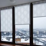 System of rolled curtains for a balcony window