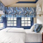Bedroom with large windows covered with roman blinds