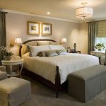 Light Roman curtains in the interior of a spacious bedroom with two windows