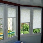 Fabric curtains with golden patterns on the windows of a private house