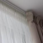 Small folds of tulle on profile cornice