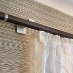 White curtain on a brown cornice