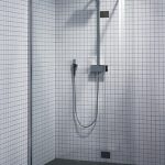 Small tile on the wall of the shower without a pallet