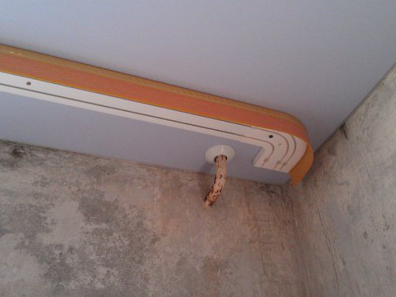 Installation of plastic cornice on the stretch ceiling