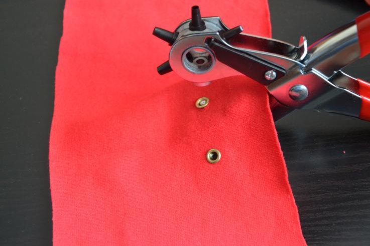 Grommet installation on red fabric
