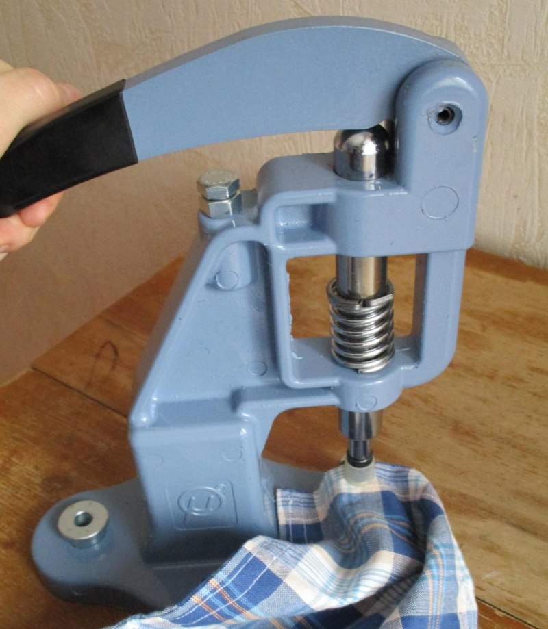 Installing the riveting on the shirt using a hand press