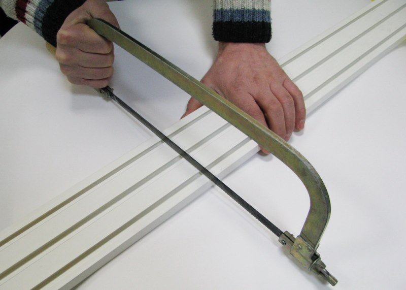 Cutting plastic eaves with a hacksaw