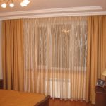 Beige curtains on the ceiling cornice