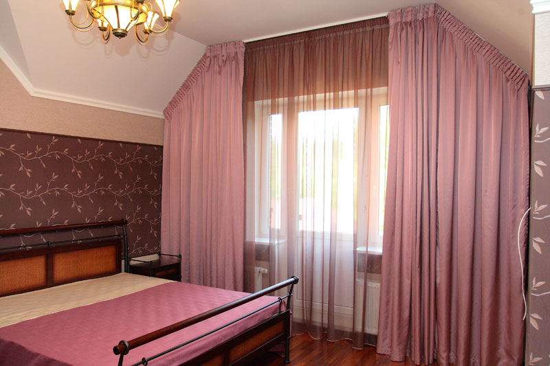 Window decoration with curtains in the attic bedroom