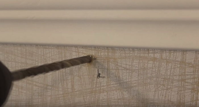 Drilling a wall when installing a curtain rail for curtains