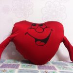 Coeur d'oreiller souriant