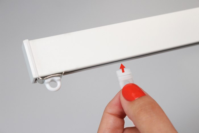 Installing the plastic runner in the groove of the aluminum cornice