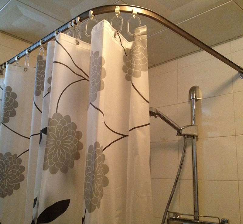 Curtain with flowers on the corner cornice in the shower