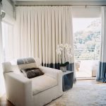 Beige curtains on the rings in the living room