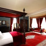 Lit à baldaquin marron et rideaux avec lambrequin dans la chambre
