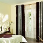 Two-color curtains and tulle on the rings in the bedroom