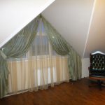 Double-layered curtains on a triangular window under the roof