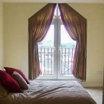 These curtains emphasize the medieval shape of a triangular window.