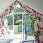 Beautiful curtains with flowers for an unusual bedroom window