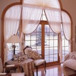 Non-standard curtains on the panoramic windows in the living room