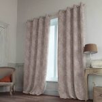 Delicate curtains with white flowers on a beige background