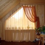 Irregularly shaped window with hooked curtains