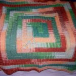 Plaid avec des aiguilles des restes de mèches de couleurs différentes