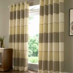 Striped curtains on a metal cornice with grommets