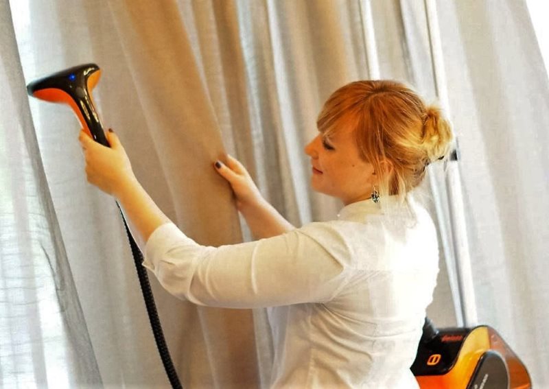 Dry cleaning of household curtains with a household vacuum cleaner