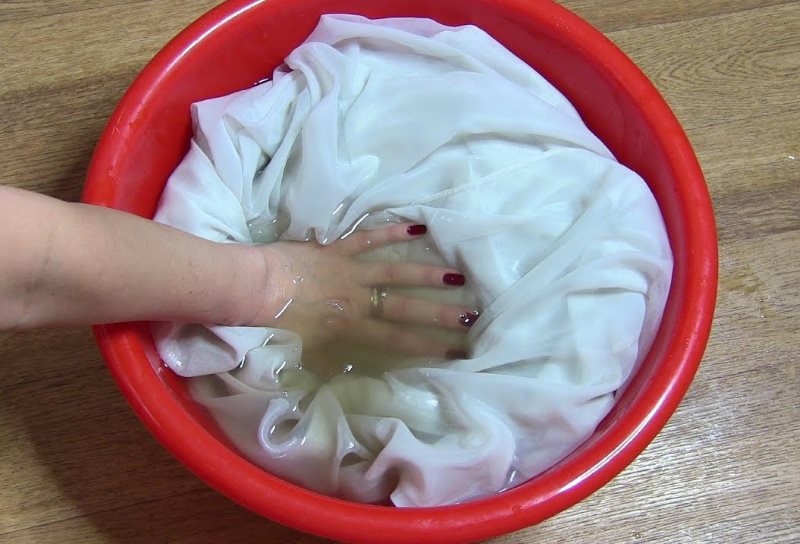 Soaking the curtains before hand washing