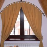 With the arched cornice you can get away from the triangular shape