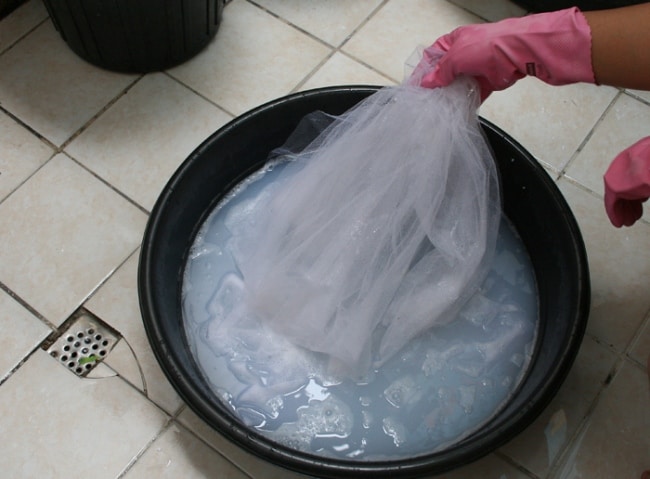 Soaking thin tulle in a plastic basin