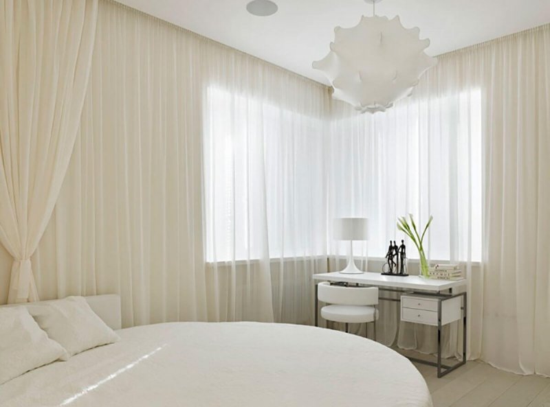 White tulle in the interior of the bedroom