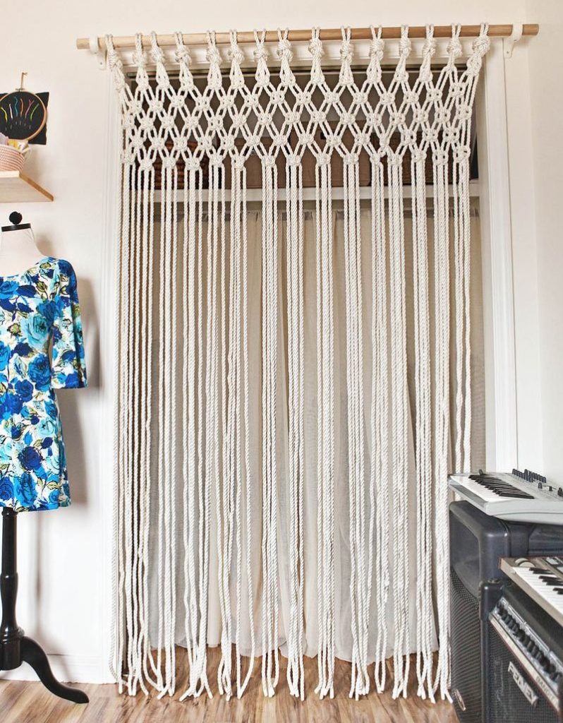 Macrame curtain on wooden cornice