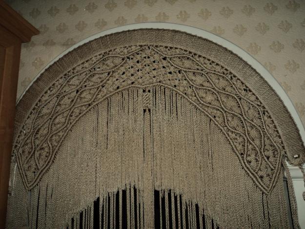 Arch doorway with a curtain of thin ropes