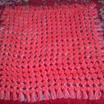 plaid corail de pompons